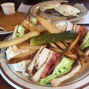 Turkey Club Sandwich with fries